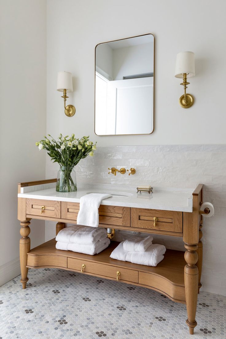 Không gian phòng tắm ấn tượng với kệ rửa bằng gỗ kết hợp với gương viền bọc vàng